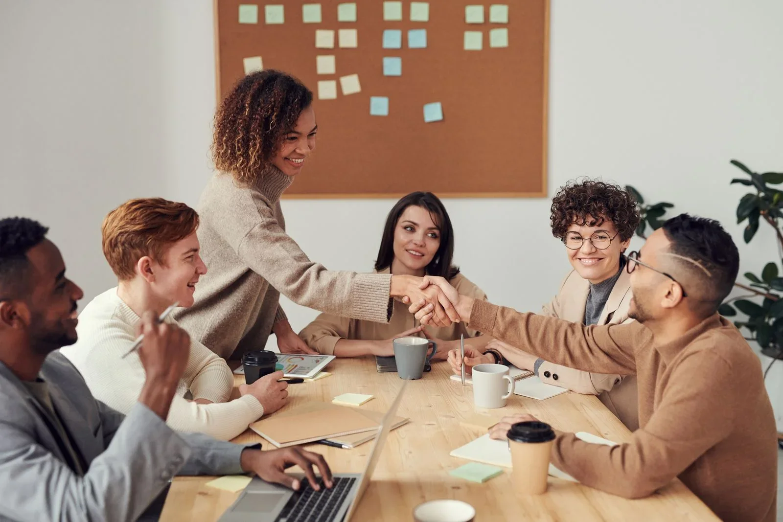 Colleagues welcoming a new team member at an office table